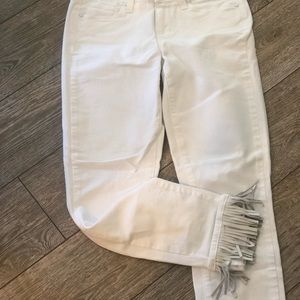 Paige white denim jeans with leather tassels.